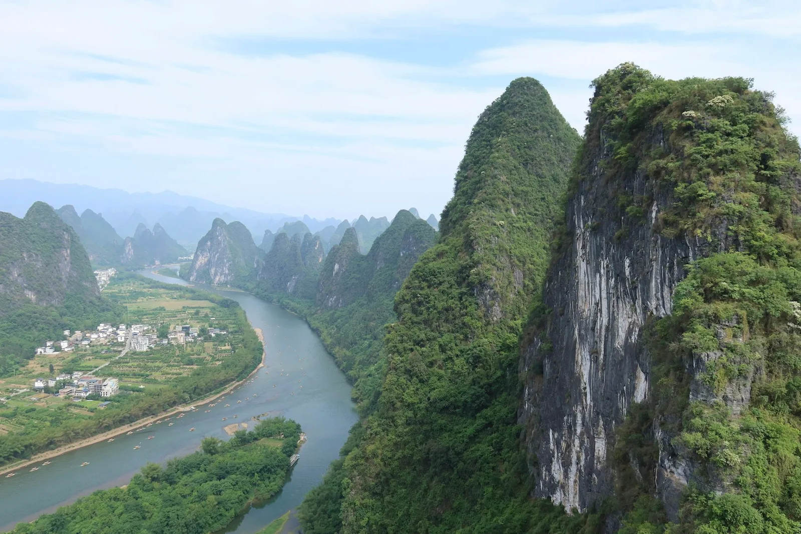 A river winds between the green karst mountains of Guilin